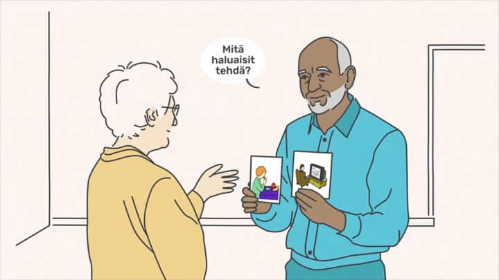 Mies kysyy naiselta "Mitä haluaisit tehdä?" käyttäen apuna kuvakortteja.